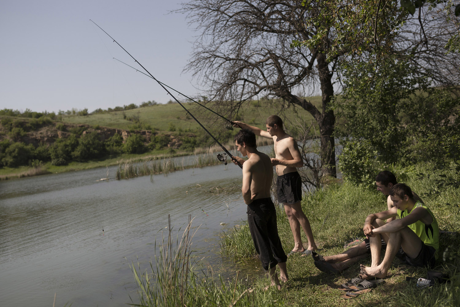 Tolek (21) and Marek (18) fishing with their friends near Davidovka. Fishing is the main hobby among miners, a much-needed relaxing activity after the stress of working underground, where every small noise might be the beginning of a deadly cave-in or of an explosion.