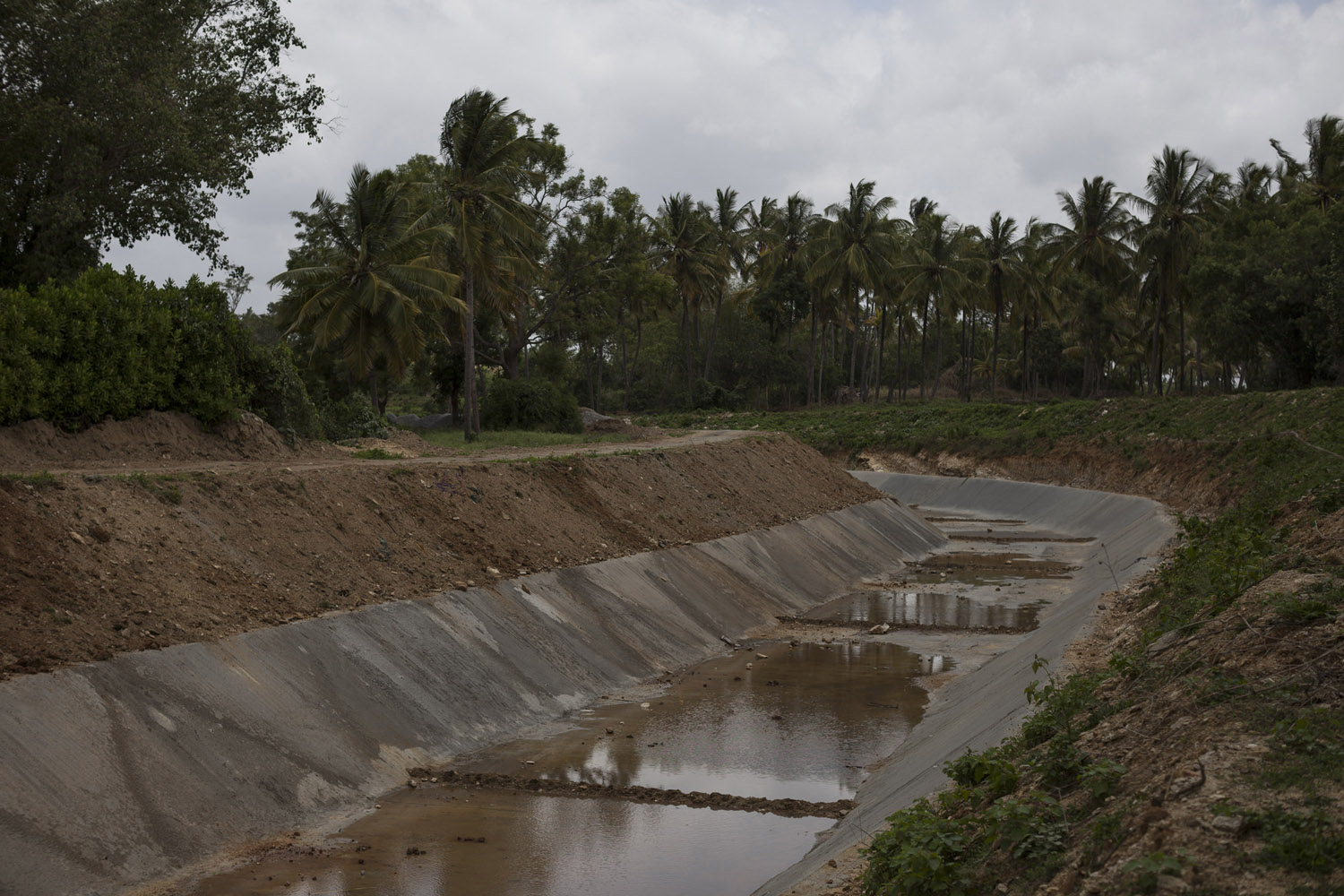 An irrigation channel from the Krishna Sagara Dam runs dry on a hot day in July, the middle of the rain season.