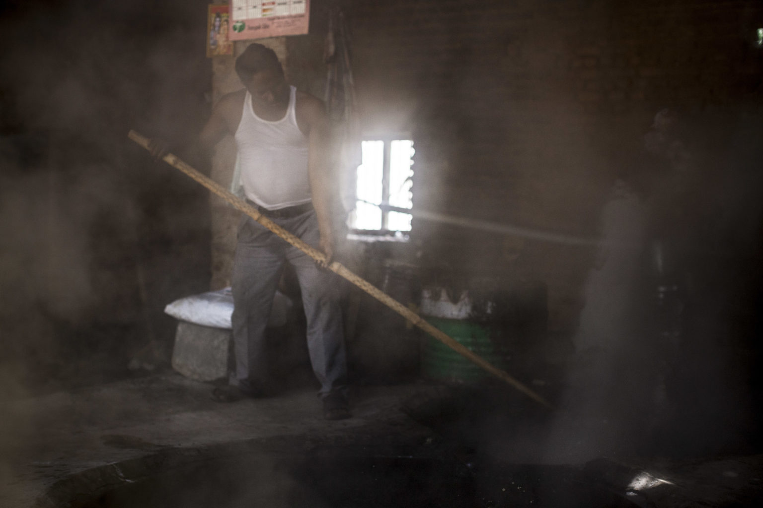 A jaggery factory in Hulivana. Jaggery is a traditional product of sugarcane, made boiling the sugarcane juice until in turns into a sweet, concentrated paste that is used to produce many Indian delicacies or is exported abroad.